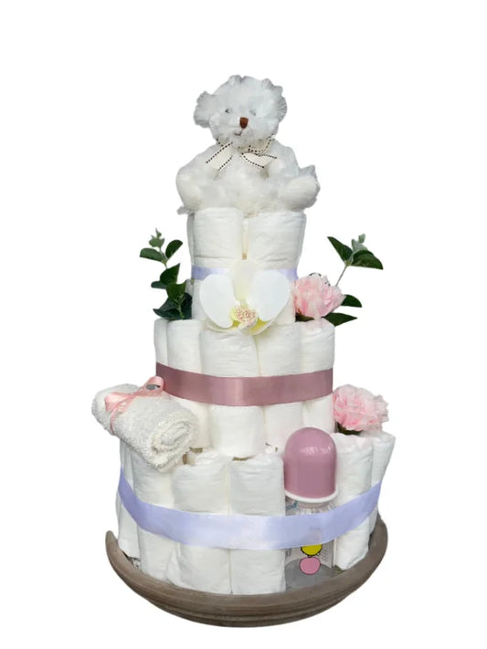 Puderrosa blöjtårta elegant med vit nalle, rosa och vita blommor, eucalyptus blad, nappflaksa och tvättlapp.